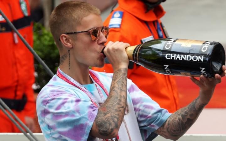 99392889_MONTE-CARLO_MONACO_-_MAY_29_Justin_Bieber_drinks_champagne_at_the_podium_during_the_Mon-large_trans++eo_i_u9APj8RuoebjoAHt0k9u7HhRJvuo-ZLenGRumA